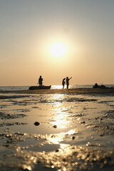 parent and child on Pattaya beach sunset