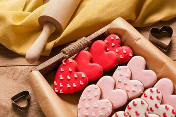 Tray with tasty heart shaped cookies, rolling pin and cutters on wooden background. Valentine's Day celebration - Powered by Adobe