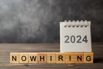 2024 calendar and wooden cubes with Now Hiring letters