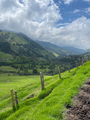 Cocora Valley in Colombia looking out into the majestic mountain valley with a fence line in the foreground