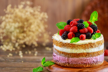 Fresh raspberries and blackberries decorate this homemade berry cake.