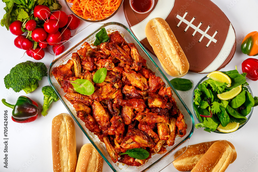 Wall mural A football game party includes wings, dip sauce and salad.