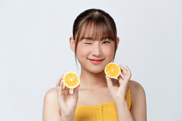 Young beautiful girl with clean perfect skin with lemon close-up. Cosmetics and care for young skin