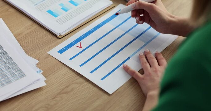 Female hand with marker putting tick on calendar date