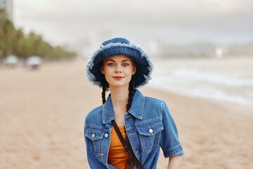 Beautiful Female Model: A Young Woman in a Stylish Hat, Posing with Sunshine and Sea as the Relaxing Background