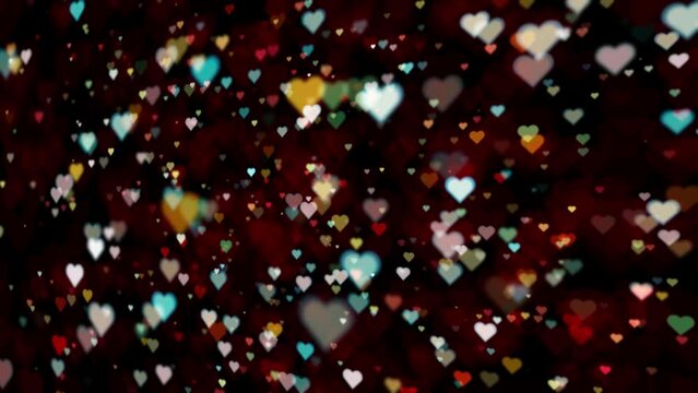 Beautiful colorful blurred heart symbol flickering bokeh loop animation.