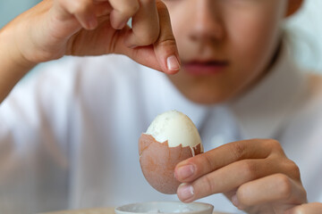 girl solid boiled egg. Close-up.