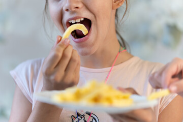 close up happy asian girl eat french fries and enjoy it a lot - unhealthy food makes people happy...