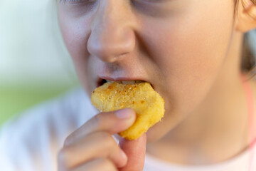 Cheerful people holding fried chicken. close up of nuggets in mouth.