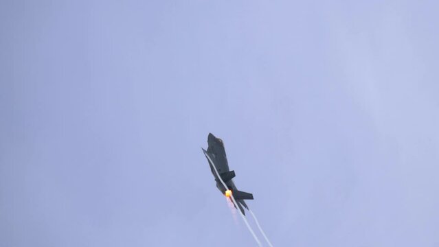 F35 Lightning II Fighter Jet in Steep Climb with Full Afterburner