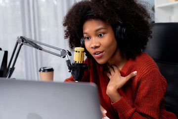 Host channel of beautiful African woman influencer talking with new listeners in broadcast studio....