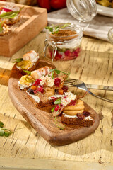 Assorted mini sandwiches with pork fat and pâté, served on a rustic Russian table