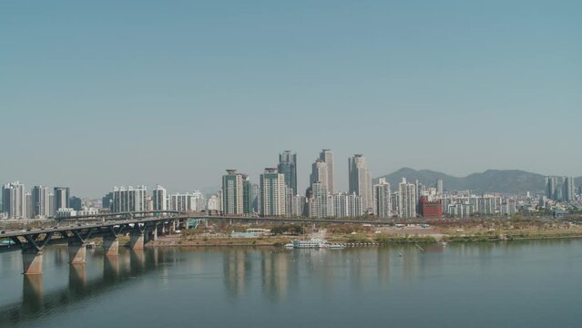 Drone Shot of Han River and Seoul Skyline With High-Rise Buildings and Bridge, South Korea