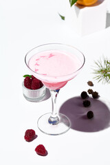 A creamy raspberry margarita cocktail with a swirl of pink and red hues, ready for a refreshing sip.