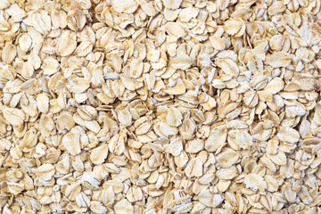 Rolled oat, oat flakes background or texture. Close up, directly above top view, close-up,