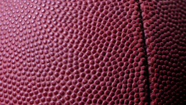 Cinematic close-up of a football, a versatile clip for various sports projects