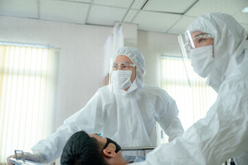 Doctor wearing face shield and PPE suit new normal working to checking a health and search data...