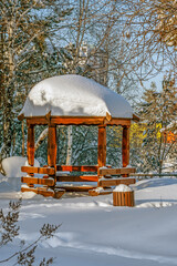 A snow-covered gazebo in the city park on a winter day