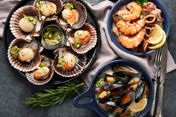Fried scallops with butter and green sauce served in seashells.