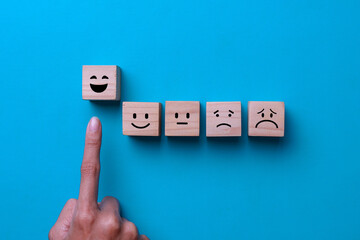 Customer service evaluation and satisfaction survey concepts. Happy face smile face icon on wooden...