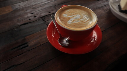red cup with coffee on wooden table background. Coffee luck