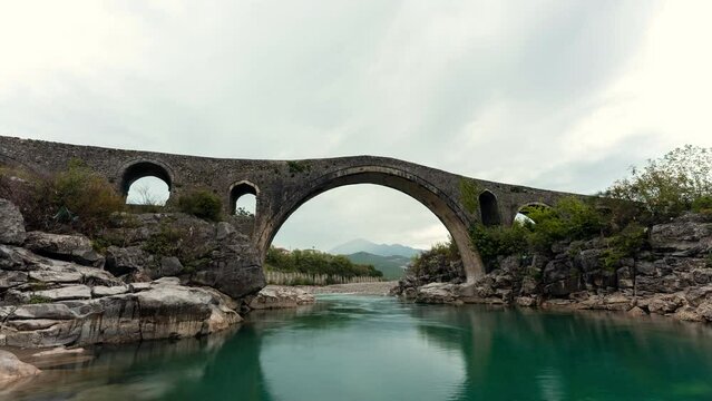 Timelapse of old historic Mesi bridge in Shkoder Albania, timelapse with river and clouds in the sky