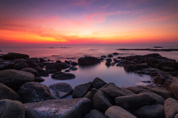 Beautiful scenery of sunset and rocks at Lan Hin Khao Beach in Rayong province, Thailand