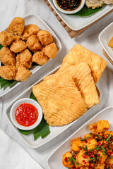 various types of food that are dipped in flour batter and then fried in lots of hot cooking oil.