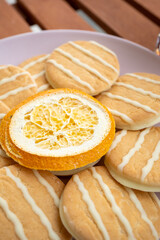 white cookies and dried orange on a plate