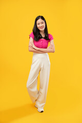 full-body portrait of an Asian woman who is happy and smiling on a yellow background