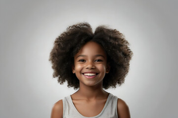 Studio portrait of a young black girl with a big curly afro hairstyle smiling at the camera. Beauty and skincare image. dental advertisement. Web design banner. - obrazy, fototapety, plakaty