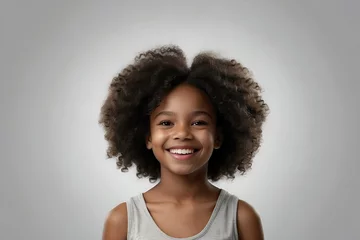 Fotobehang Studio portrait of a young black girl with a big curly afro hairstyle smiling at the camera. Beauty and skincare image. dental advertisement. Web design banner. © PixelHarmony