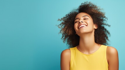 Portrayal of a joyous young woman against a solid color background