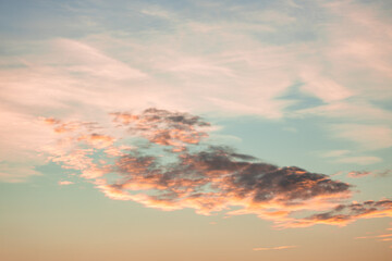 A beautiful sky tinted by the sun leaving vibrant shades of gold, pink, blue and multicolored. Clouds in the twilight evening and morning sky. Cloudy sky background in the evening and during the day.