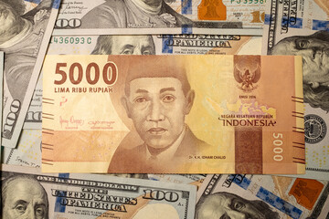 hand with dollars and Indonesia money