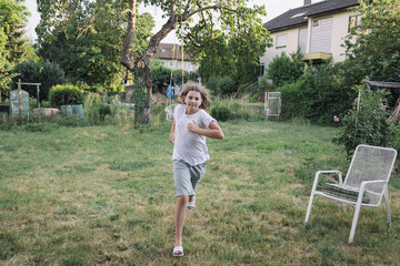 two teenage  play in the summer garden near the house. Country life.