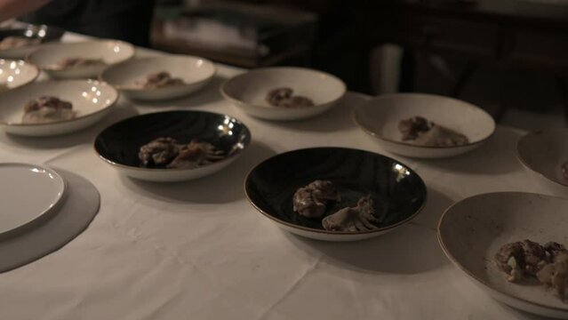 Catering team preparing dishes for diners.