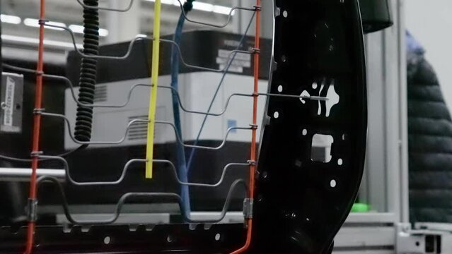 Installing an armrest bracket on the backrest of the car seat