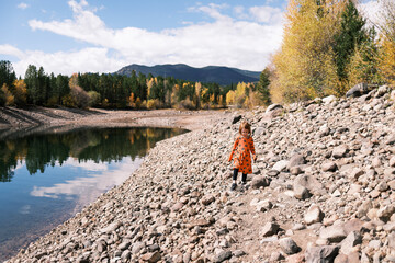 Girl hiking along the rocky shore of Dillon reservoir, Colorado