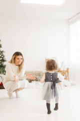 Fototapeta na wymiar Toddler Dressed Up Enjoying Christmas with Family