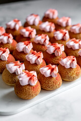 Eclair choux with pink frosting and a red berry powder