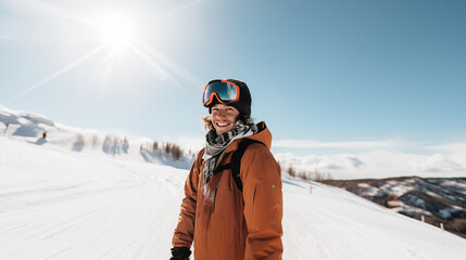 Fototapeta na wymiar young man in orange ski suit and ski goggles on a winter sunny d