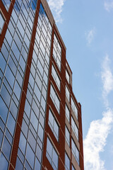 Brick building reflecting blue sky