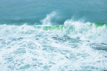 Wave splashing close-up. Crystal clear sea water, in the ocean in San Francisco Bay, blue water, pastel colors.
