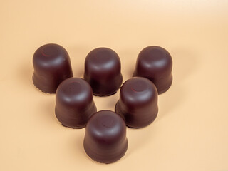 Marshmallows in chocolate glaze on an orange background. Marshmallow close-up.