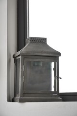 Small lantern in a corner of the room.
