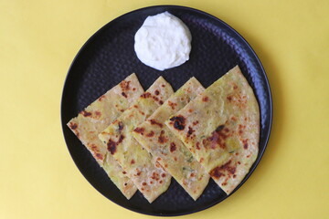 Potato Stuffed Flat Bread or Aloo paratha is a Traditional Indian food, served with curd
