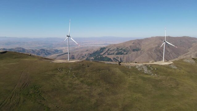 Drone view of modern wind turbine producing clean and renewable energy in the countryside