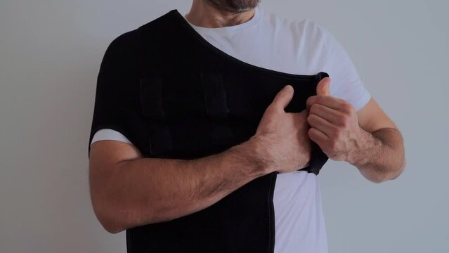 Shoulder orthosis orthoses orthopedic medical recovery sling for support hand background.