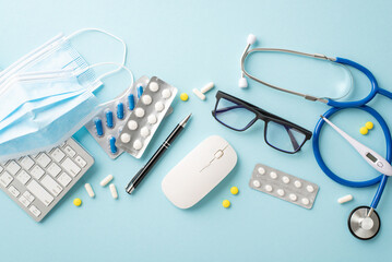 Remote health check concept. Overhead shot of keyboard, mouse, stethoscope, masks, pills, thermometer, and glasses on a pastel blue surface, featuring space for text or promotional content